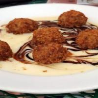 Risotto Bites · Vegetarian. Parmesan and panko crusted risotto balls, served with honey beurre blanc and bal...
