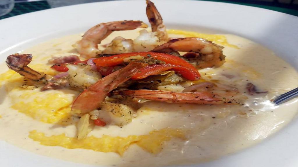 Shrimp & Grits · Gluten-free. Roasted corn and cheddar grits with buttery garlic shrimp, sautéed bell peppers and red onions, topped with a smoky ham and chorizo gravy.