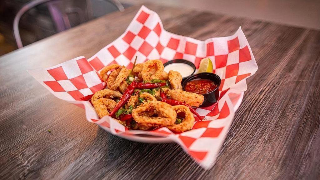 Calamari · Flash-Fried Calamari Rings Tossed in Pickled Peppers + Green Onions + Red Calabrian Chiles Served with Spicy Marinara + Lemon Basil Aioli