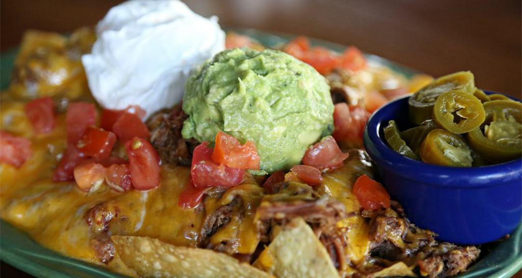 Nachos Supreme · Corn tortilla chips, shredded beef or pork, mixed cheese, sour cream, guacamole, re-fried beans, tomatoes, jalapenos upon request.