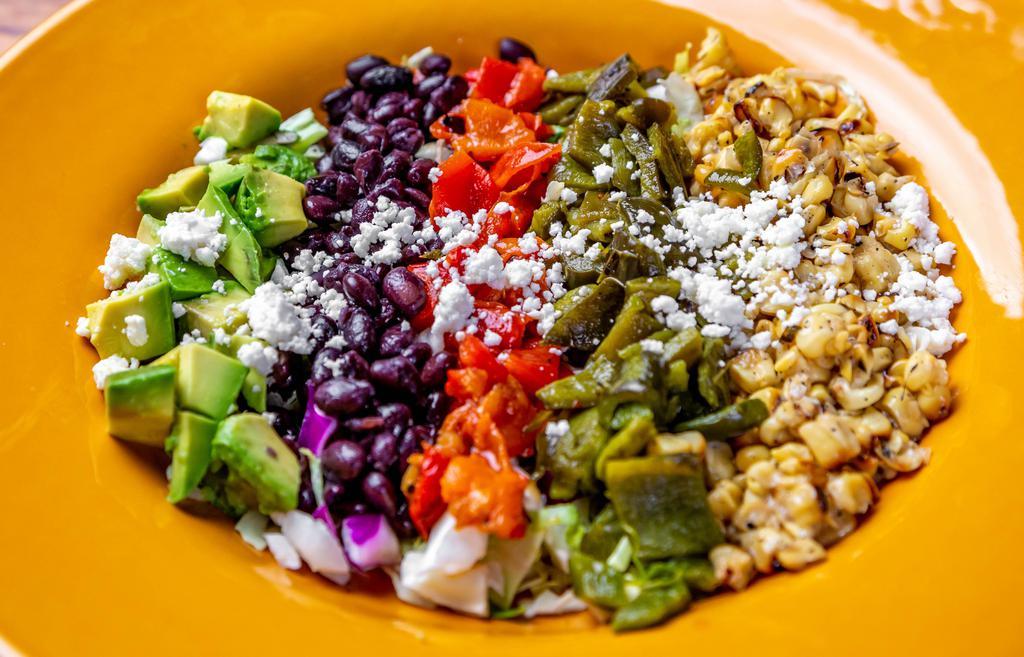 Harvest Chopped Salad · Fire-roasted poblano chile, red bell pepper, grilled corn, black beans, Mexican cheese & diced avocado. Served with creamy cilantro ranch
