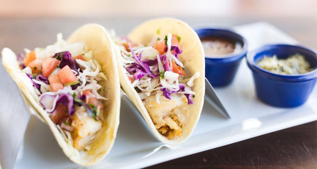 Seasonal Fish Tacos · Grilled on corn tortillas with shredded cabbage, pico de gallo and chipotle taco sauce.