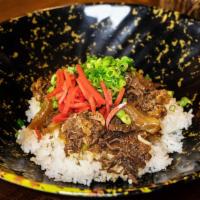Beef Gyudon Rice Bowl  · Sweet marinated slow-cooked niku beef and onions topped on steamed white rice. Garnished wit...