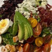 Cobb Salad · Chicken, avocado, bacon, egg, blue cheese crumbles, tomato, olives.