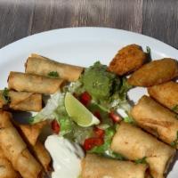 Mini Appetizer Platter · Beef flautas, machaca chimis, chicken and cheese rollups, and stuffed jalapeño poppers, serv...