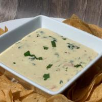 Queso Fundido Dip · Spicy cream cheese and jalapeño dip with spinach and pico de gallo.