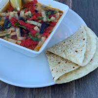 Tortilla Soup - Cup · Corn tortilla strips with chicken, fresh green chiles, tomatoes and onions, served in a spic...