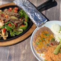 Fajitas · Half pound of grilled steak, chicken breast, or shrimp sautéed with onions, tomatoes, fresh ...