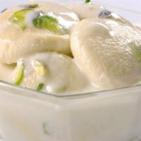 Rasmalai · Home-made cheese patties in creamy pistachio sauce