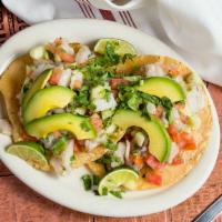 Tostada De Ceviche · Colima lime marinated fish or shrimp (raw!), cool cucumber,  fresh tomato  and zesty onion, ...