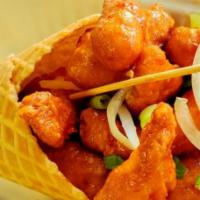 Chicken Waffle Cone · Waffle cone with your choice of different flavored chicken: cheesy, sweet chili, or maple ba...
