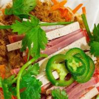 Banh Mi Bites · Sliced Banh Mi toasted in our sauce, with dried shredded pork, Vietnamese red and white hams...