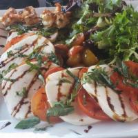 Caprese Salad · Sliced tomatoes, sliced buffalo mozzarella, spring mix tossed in oil and vinegar and fresh b...