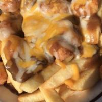 Poutine Fries · British specialty. Steak fries topped with white cheddar cheese curds then smothered in brow...