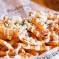 Buffalo Fries · Skinny fried topped with blue cheese crumbles, drizzled buffalo sauce and ranch dressing.