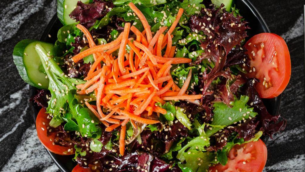 Moto House Salad · Gluten-free. Mixed greens in a sesame soy vinaigrette served with cucumbers, tomatoes, carrots.