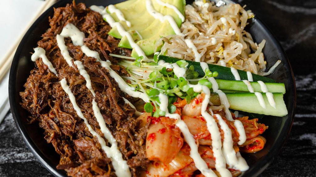 Kalbi Bowl · Gluten-free. Korean style shredded beef, kimchi, cucumber, sesame bean sprouts, spicy sprouts, avocado, jalapeño dressing.