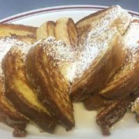French Toast · Four large French toast topped with powdered sugar.