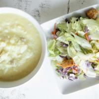 Soup & Salad · A bowl of our homemade chicken lemon rice soup and our house salad served with garlic bread.