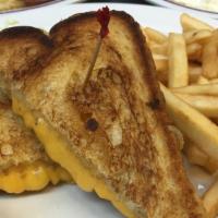 Grilled Cheese · Melted cheese on white bread with French fries.