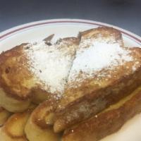 French Toast · Two pieces of French toast topped with powdered sugar.