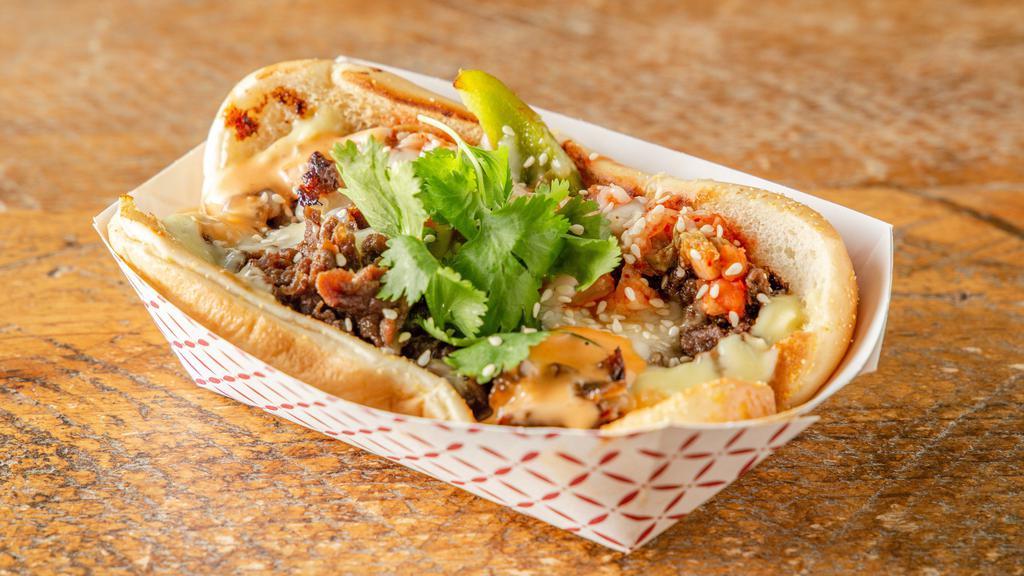 Korean Cheesteak · Sautéed kimchi, onoions, and bell peppers with choice of protein. Smothered in mozzerela and served with wasabi mayo, and 1000 island on a hoagie bun.