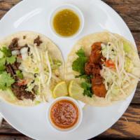 Taco · Corn tortilla, with choice of meat. Layered with cabbage, cucumber, pico de gallo bean sprou...