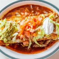 Deluxe Burrito · Wet burrito filled with rice, refried beans and meat. Topped with tomato, lettuce, guacamole...