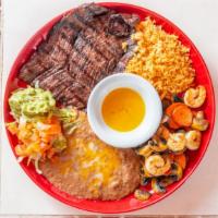 Mar Y Tierra · Carne asada steak and prawns mojo de Ajo combo. Served with rice, refried beans, and tortill...