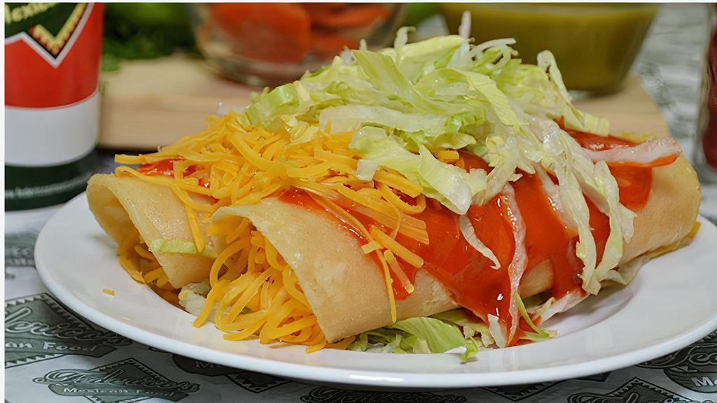 Cheese Enchiladas · Two cheese enchiladas topped with cheese and lettuce.