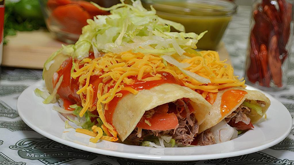 Beef Enchiladas · Two shredded beef enchiladas (beef mixture of onion, tomato, and bell pepper) topped with cheese and lettuce.