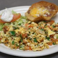 Huevos A La Mexicana · Scrambled eggs with onions, tomatoes and peppers. With corn or flour tortillas.