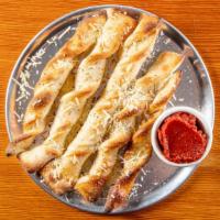 Homemade Breadsticks · Most popular. Warm breadsticks served with house red sauce.