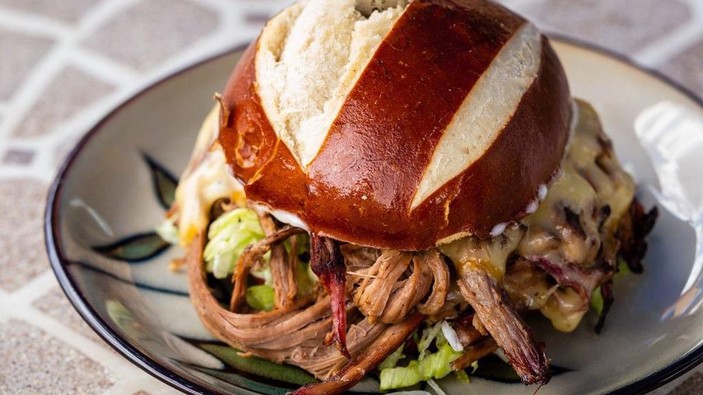 Brisket Sandwich · Texas style slow smoked Brisket with our House made Rub, Smoked Gouda cheese, Mayo, and
lettuce on a Pretzel bun.