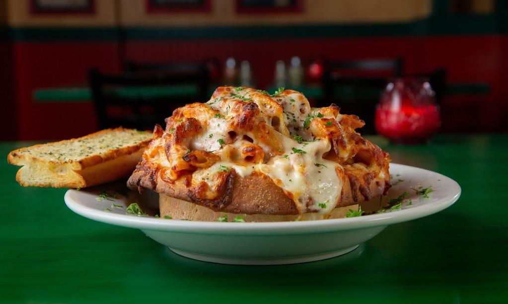 Zany Ziti · Ziti pasta, meat sauce and four Italian cheeses are topped with Wisconsin cheese, baked in a bread bowl and sprinkled with oregano.