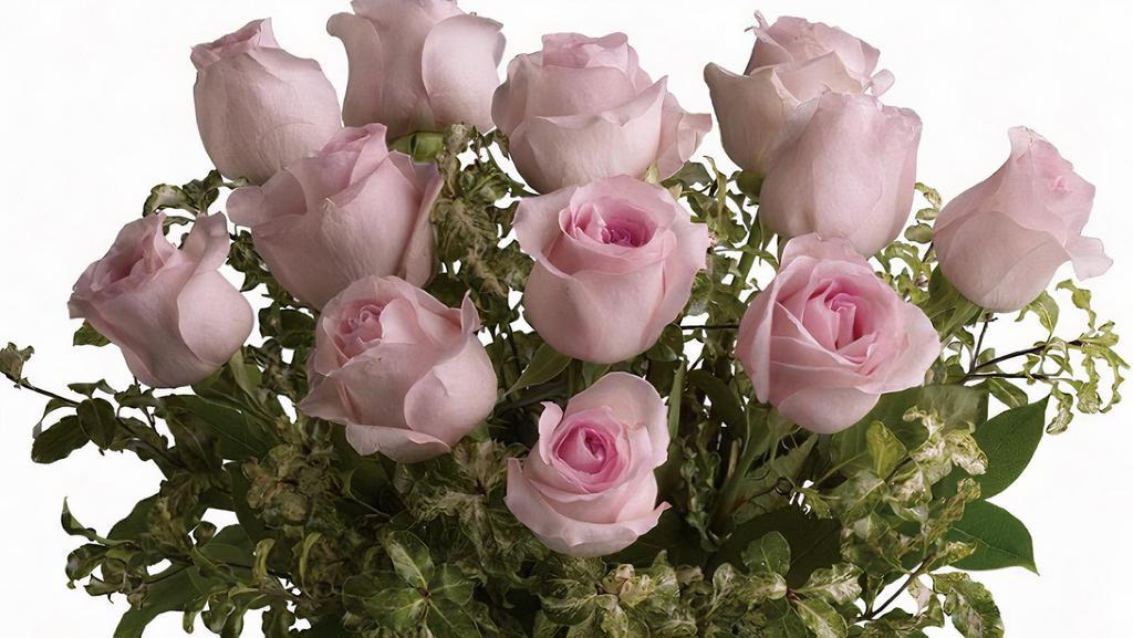 One Dozen Pink Medium Stem Roses Arranged In A Vase · One Dozen florist quality medium stem roses will be arranged as a bouquet  in clear  glass vase with a filler flower.