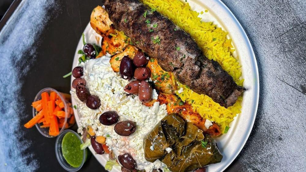 Steak Shawarma Plate · Steak shawarma served over a plate of rice with Mediterranean salad, your choice of veggies and tahini or tzatziki dressing.