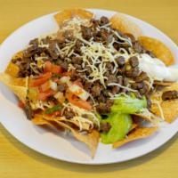 Super Nachos · Chips, choice of meat with cheese, beans, pico de gallo, sour cream and guacamole.