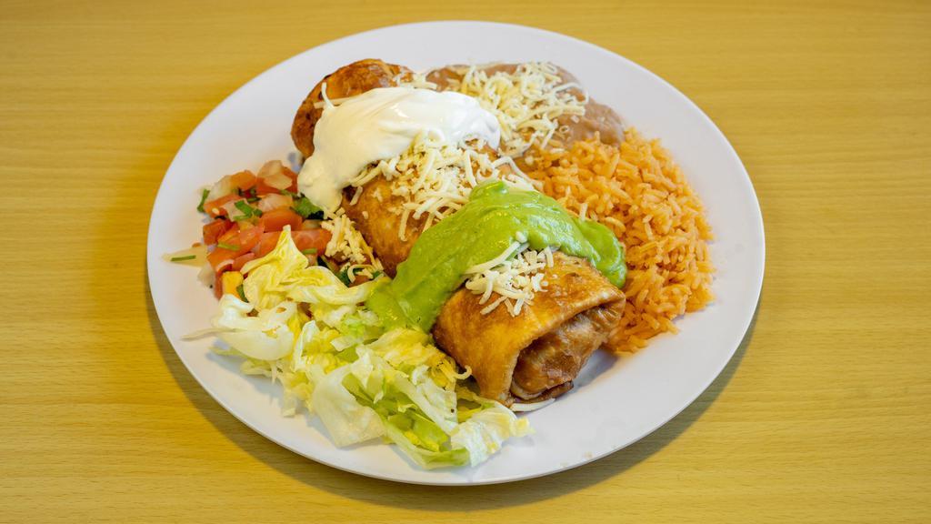 # 16 Chimichanga · Chimichanga filled with (beef or chicken), beans and cheese with , lettuce, guacamole and sour cream on a plate with rice and beans.