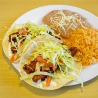 #5 Fish Tacos (2) Plate · Two fish tacos (cod fish) with pico de gallo, cabbage, and tartar sauce on a plate with rice...