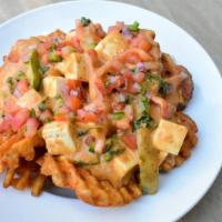 Panang Poutine · waffle fries loaded with panang curry gravy, soft tofu, bell peppers, thai basil, and topped...