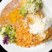 Chimichanga · Meat & beans wrapped in a flour tortilla, deep fried, topped w/ sour cream, cheese & guac, r...