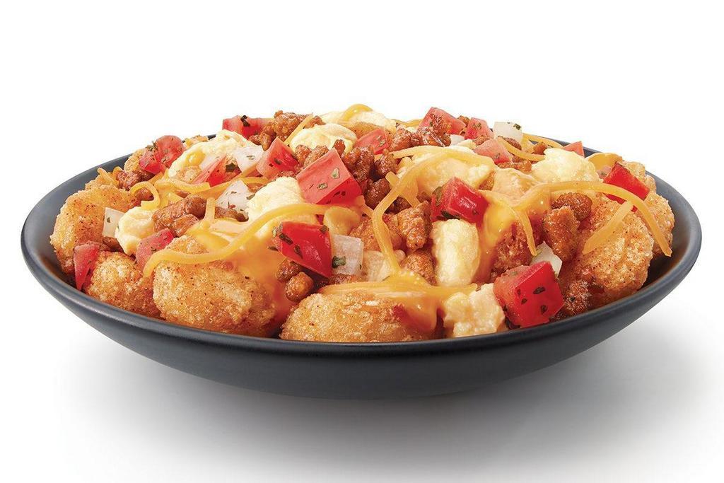 Potato Olés® Scrambler · The best way to start your day off the Ole® Way. Potato Olés® covered in Nacho Cheese, Scrambled Eggs, Diced Onions, Cheddar Cheese, Poblano Peppers, Tomatoes and your choice of Bacon or Chorizo Sausage.