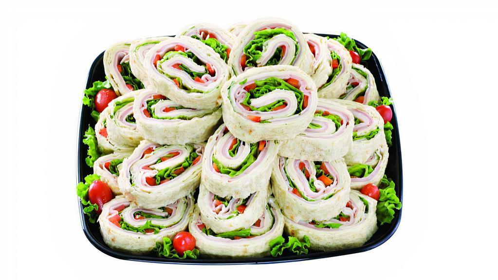 Pinwheel Snack Squares - Small · Soft Lavosh bread layered with Cream Cheese, Baked Ham, Premium Turkey Breast, Provolone, Tomato, Green Leaf Lettuce and deli-sliced Pickles. Serves 8-10.
