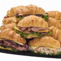 Croissant Sandwiches - Small · Flaky, light and buttery croissants layered with Baked Ham, Roast Beef, Premium Smoked Turke...