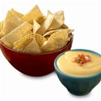Chips & Queso · Vegetarian. Gluten-free. Crispy tortilla chips and cheesy goodness.
