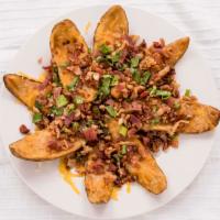 Quinn'S Potato Skins · Quinn's famous homemade potato skins topped with bacon bits, melted cheese, and green onions...