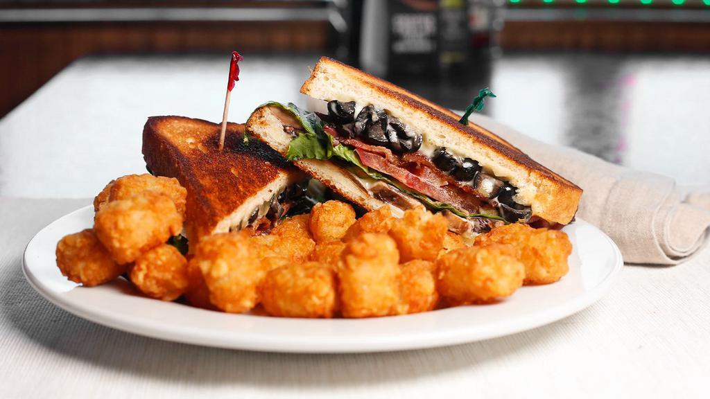 Quinn'S Specialty Grilled Cheese Supreme · American and Swiss cheese, bacon, mac, lettuce, tomato, mushrooms, artichoke hearts, and olives. Served on whole wheat bread with your choice of side
