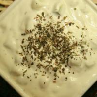 Maust -O- Khiar · Diced cucumber mixed in yogurt. Topped with dried mint.