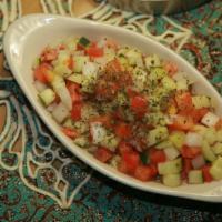 Shirazi Salad · Diced cucumbers, tomatoes and, onions with olive oil and lemon juice.